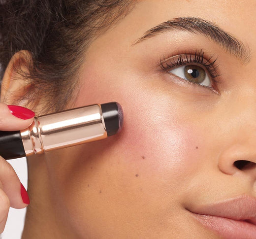 woman applying blush